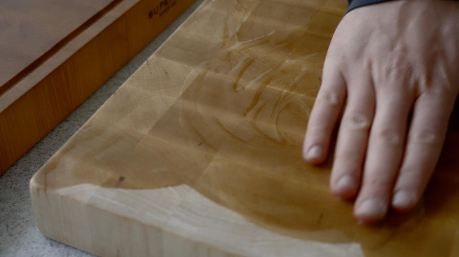 Oiling an end grain cutting board with mineral oil.